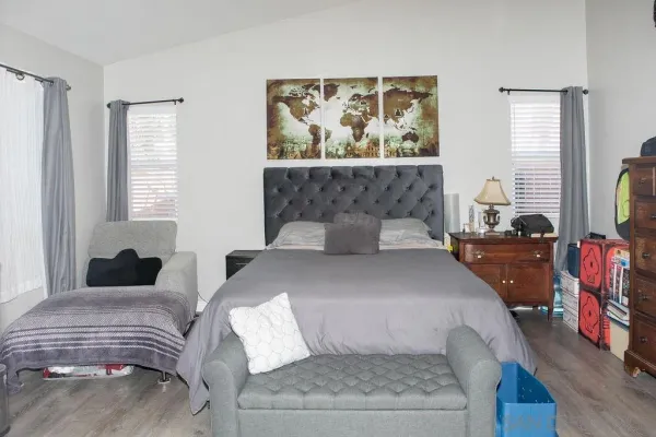 a bedroom with a large bed and a window