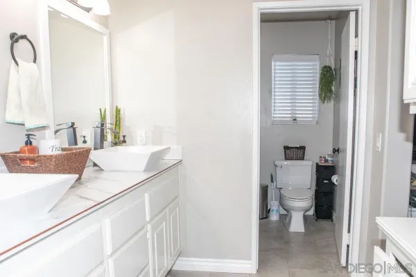 a bath room with a sink and a toilet