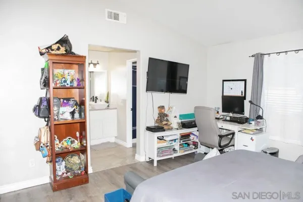 a living room with furniture a flat screen tv and a window