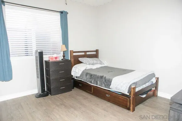 a bedroom with bed and a flat tv screen