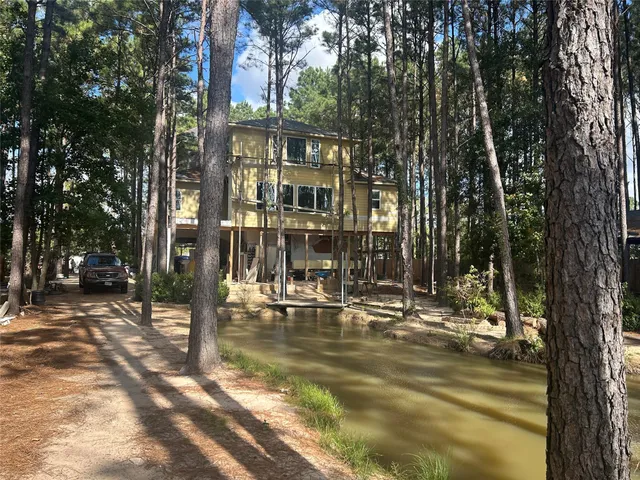 a view of a house with backyard porch and sitting area