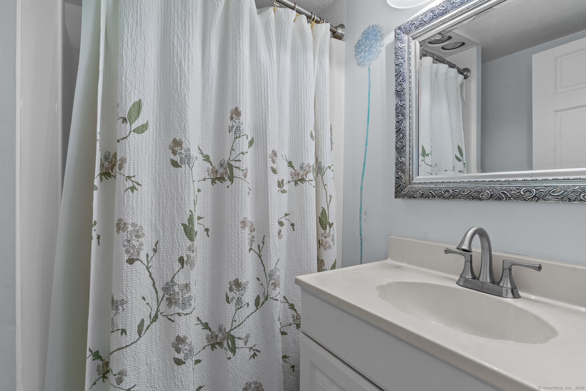 76 New Shore Road Waterford, CT 06385 - Photo 12 of 23 a bathroom with a sink and a mirror