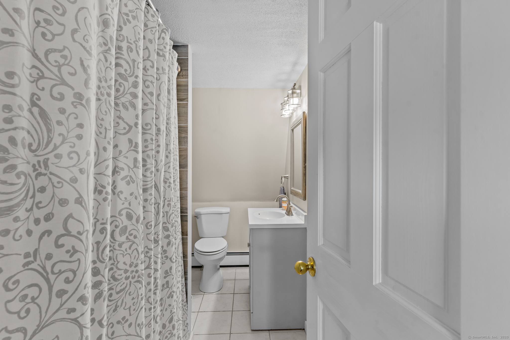 76 New Shore Road Waterford, CT 06385 - Photo 19 of 23 a bathroom with a shower curtain