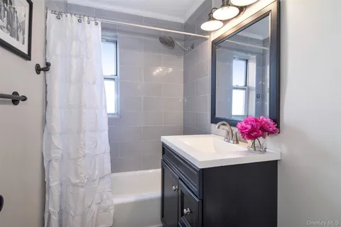 a bathroom with a sink vanity and a mirror