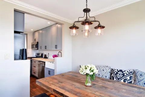 a kitchen with a table and chandelier