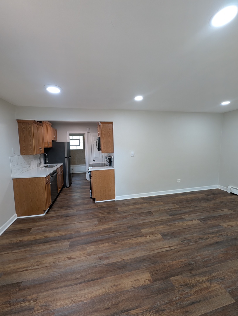 4303 South Harlem Avenue, Unit 6 Stickney, IL 60402 - Photo 3 of 13 a living room with hard wood floors and kitchen view