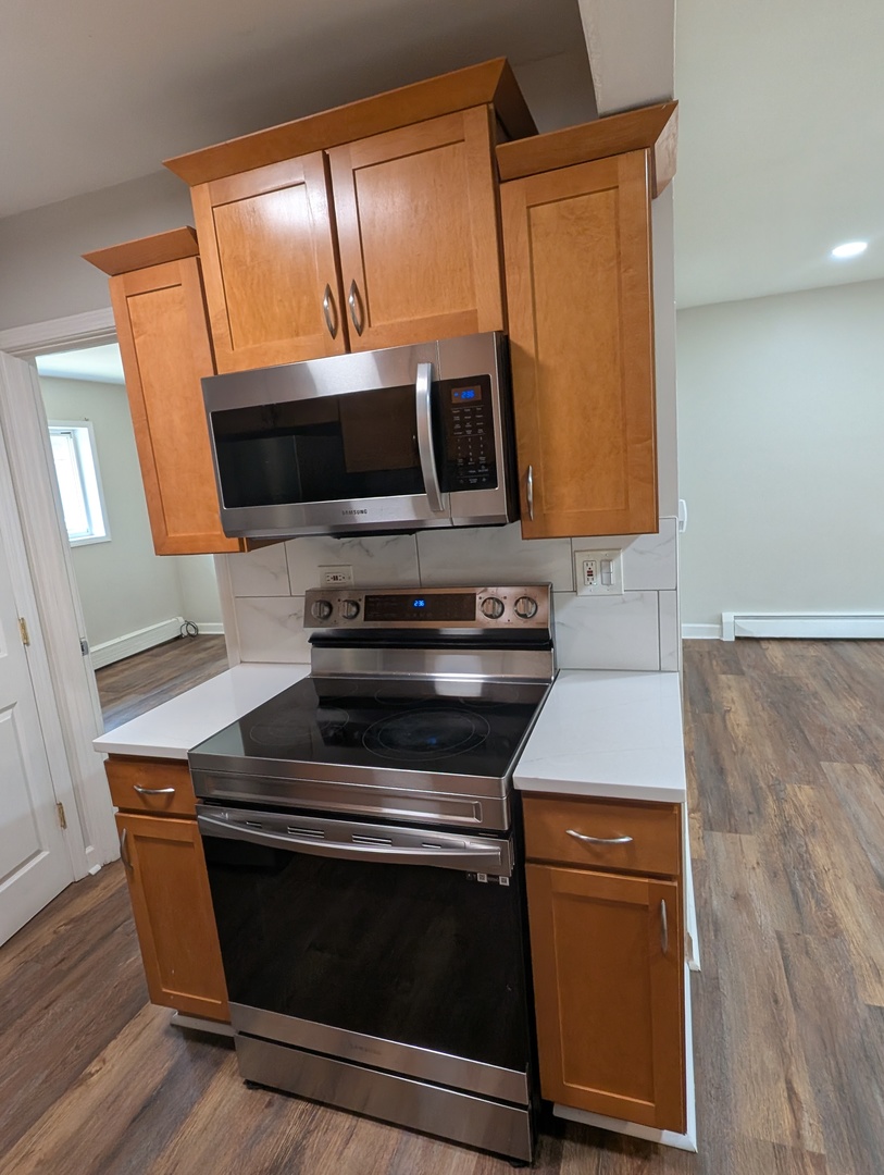 4303 South Harlem Avenue, Unit 6 Stickney, IL 60402 - Photo 6 of 13 a kitchen with wooden cabinets and a stove top oven
