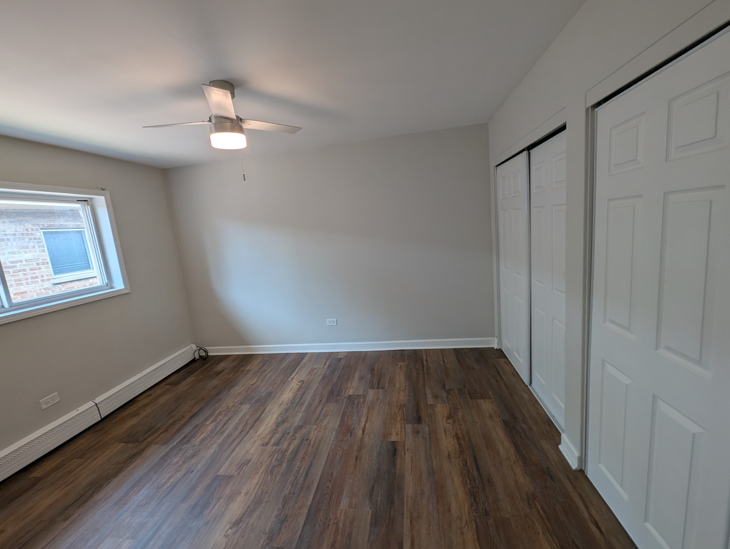 4303 South Harlem Avenue, Unit 6 Stickney, IL 60402 - Photo 8 of 13 wooden floor in an empty room with a window