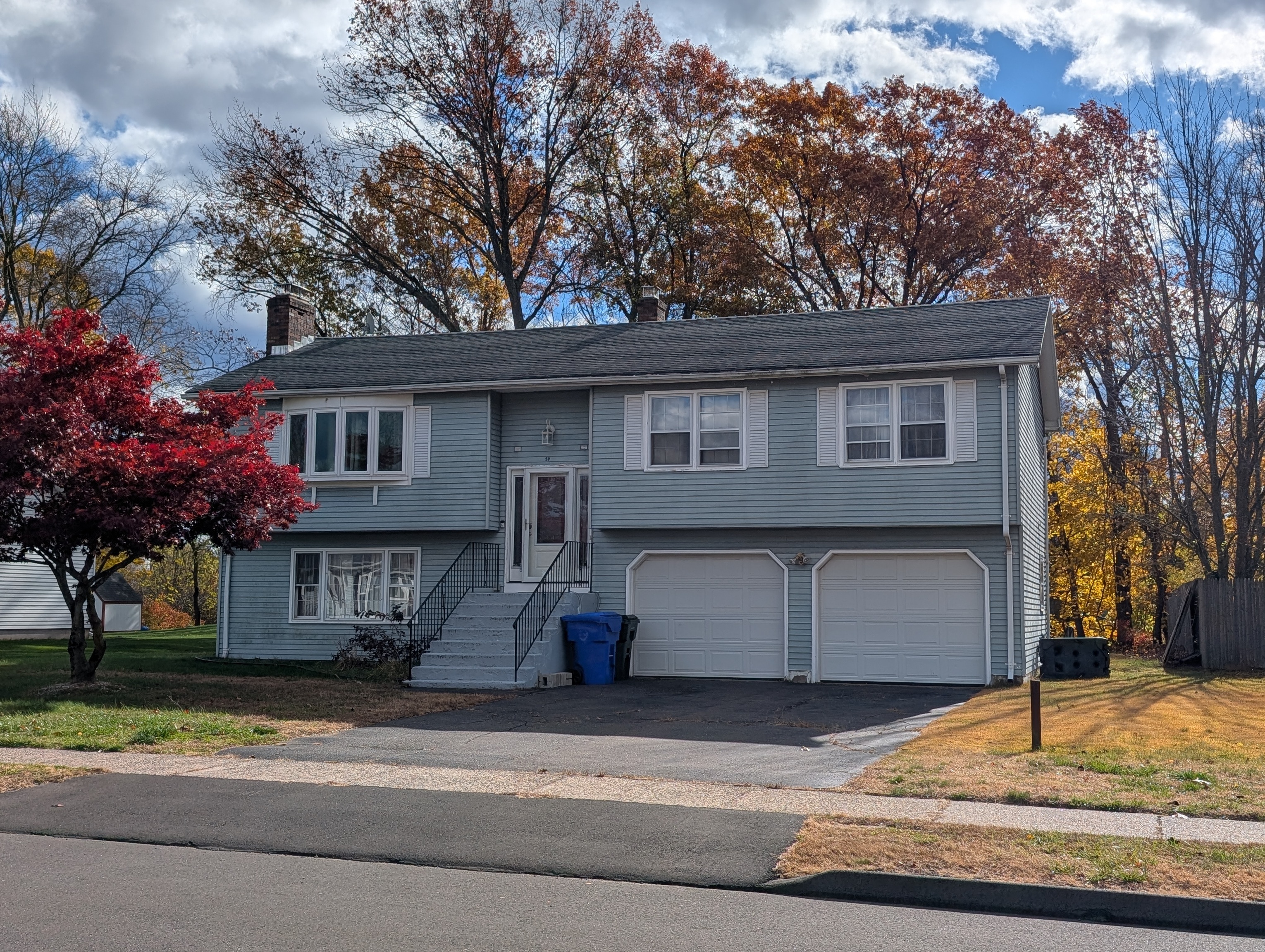 59 Pheasant Lane East Hartford, CT 06108 - Photo 2 of 8 a front view of a house with a yard and garage