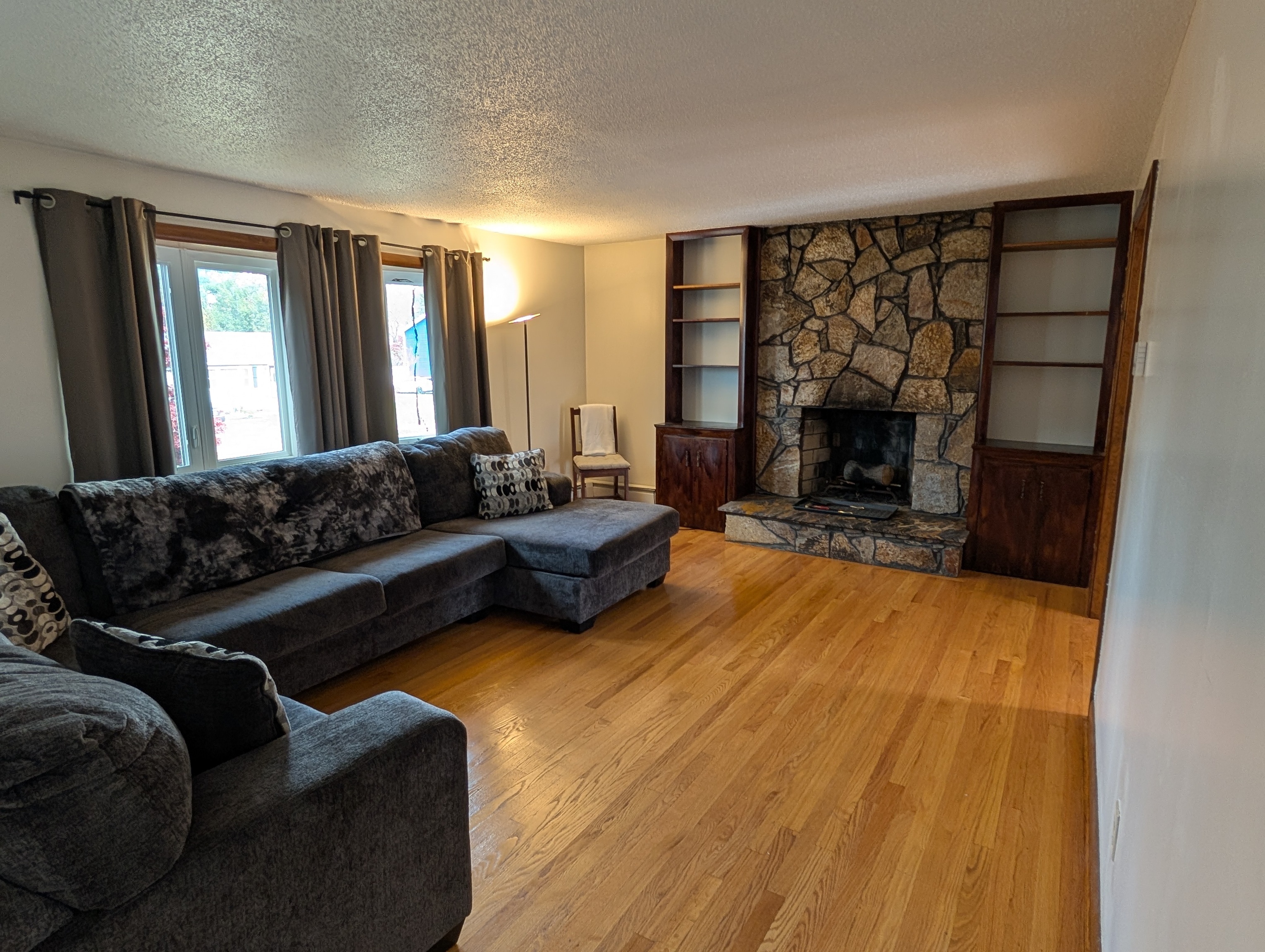 59 Pheasant Lane East Hartford, CT 06108 - Photo 5 of 8 a living room with furniture and a fireplace