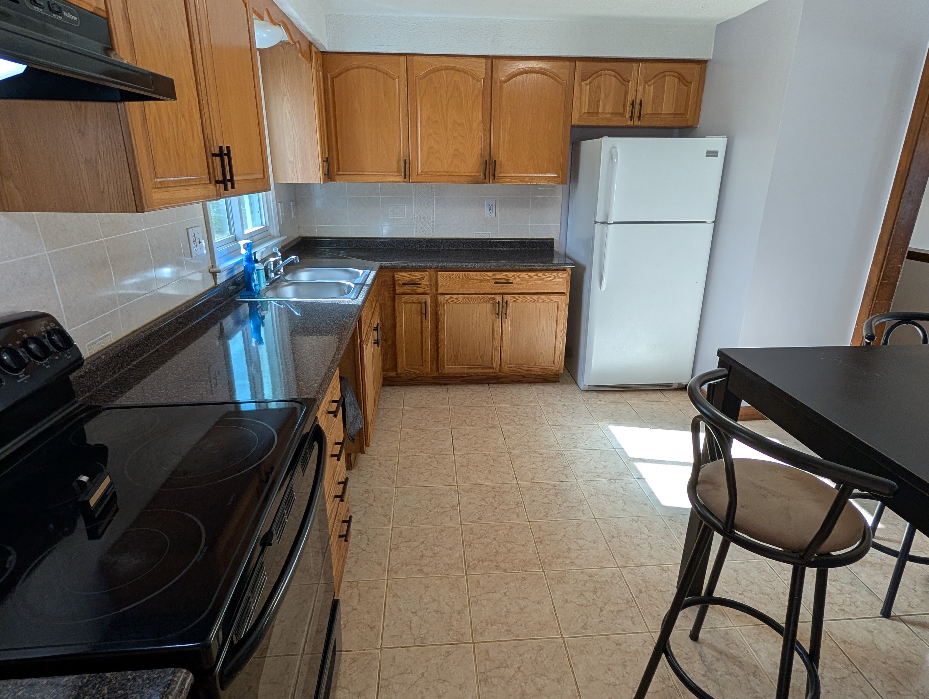 59 Pheasant Lane East Hartford, CT 06108 - Photo 8 of 8 a kitchen with a sink appliances and cabinets