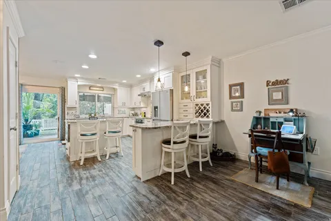 a dining room with furniture and wooden floor