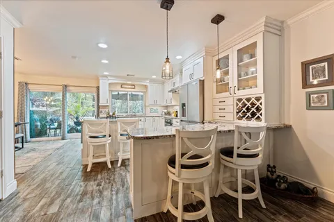 a dining room with furniture a chandelier and wooden floor