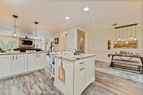 a kitchen with kitchen island granite countertop a stove and a sink