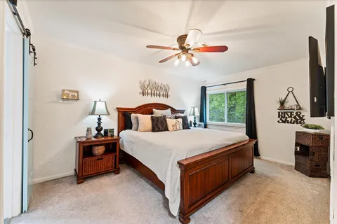 a bedroom with a bed and a chandelier
