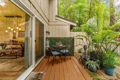 a view of a balcony with chairs and wooden floor