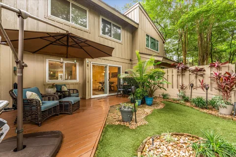 a backyard of a house with barbeque oven table and chairs