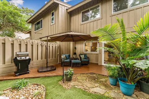 a view of house with a yard and a fence