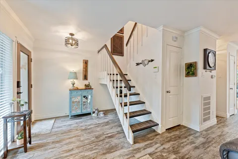 a view of entryway and hall with wooden floor