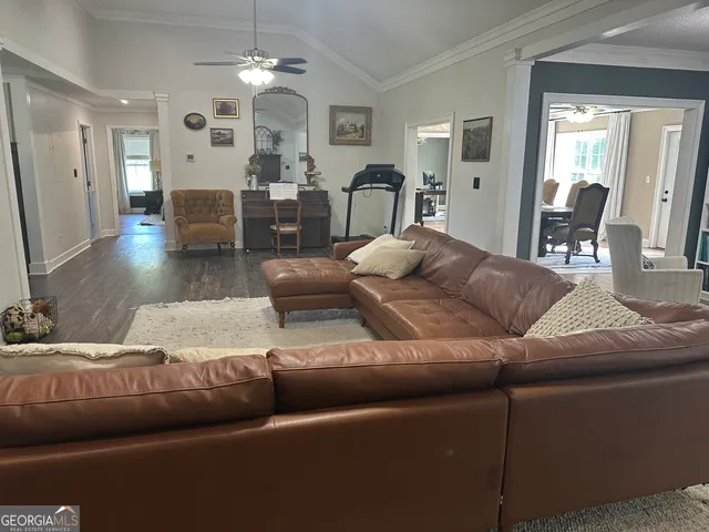 a living room with furniture and a chandelier