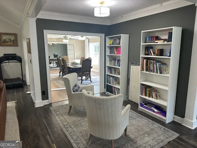 a living room with furniture and a book shelf