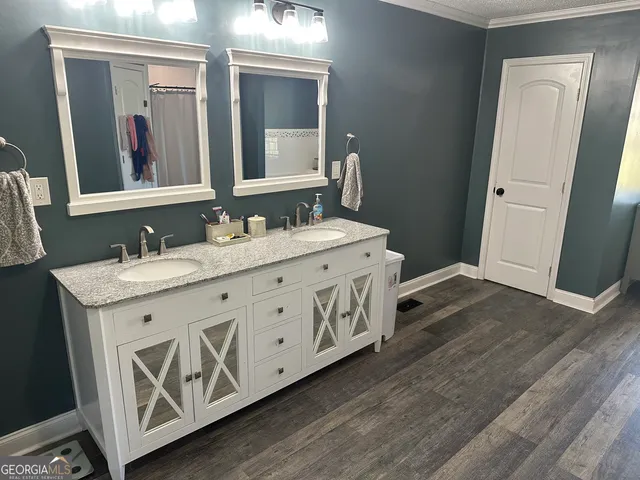a spacious bathroom with a double vanity sink and a mirror