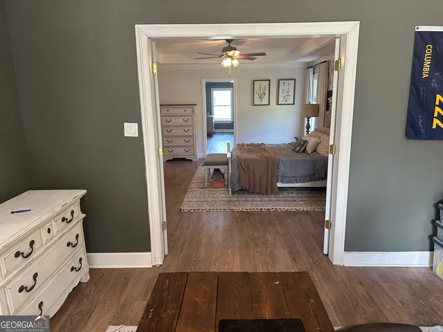 a hall way with furniture and wooden floor