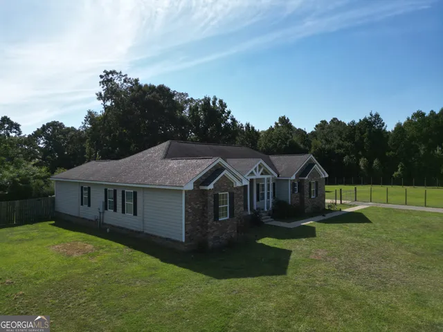 a view of a house with a yard and sitting area