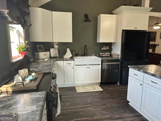 a utility room with cabinets washer and dryer