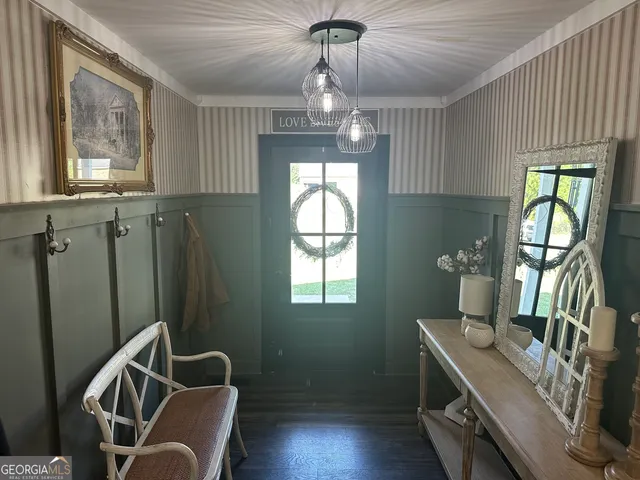 a view of a livingroom with furniture window wooden floor and chandelier