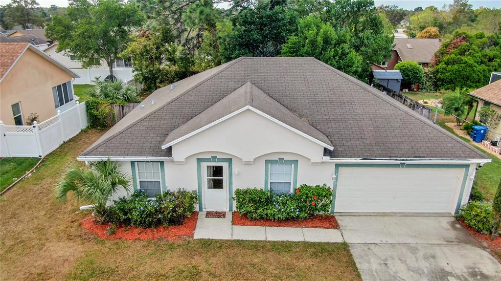 4393 Union Springs Road Spring Hill, FL 34608 - Photo 1 of 1 a view of a house with a yard and potted plants