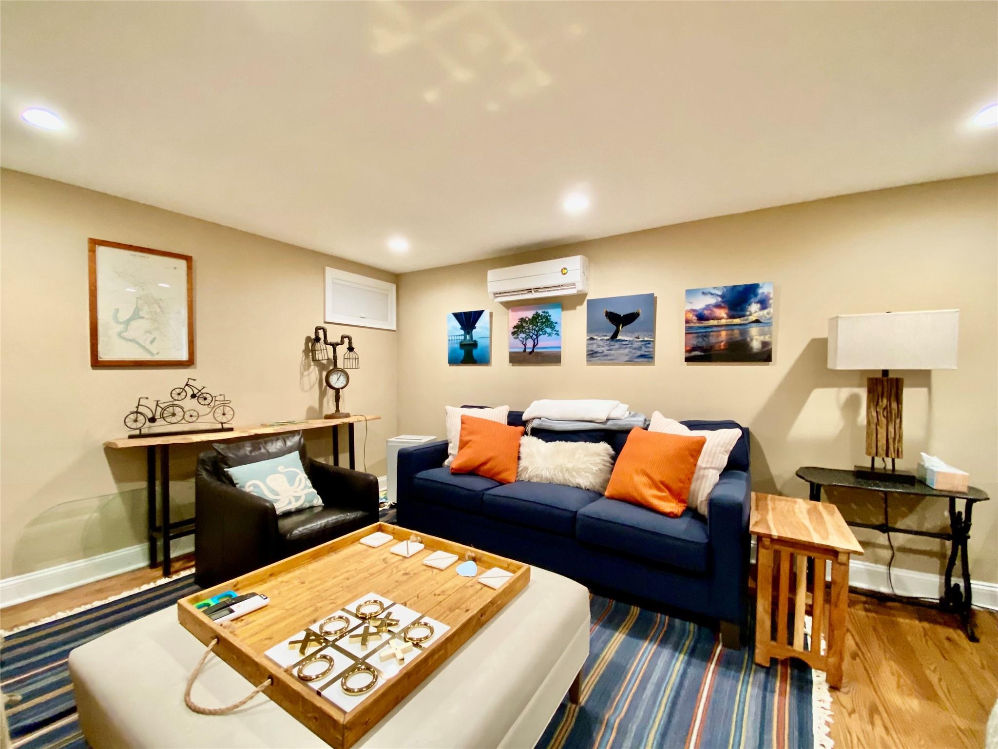 780 Minnehaha Boulevard Southold, NY 11971 - Photo 13 of 23 Living area featuring a wall mounted air conditioner, wood finished floors, and recessed lighting