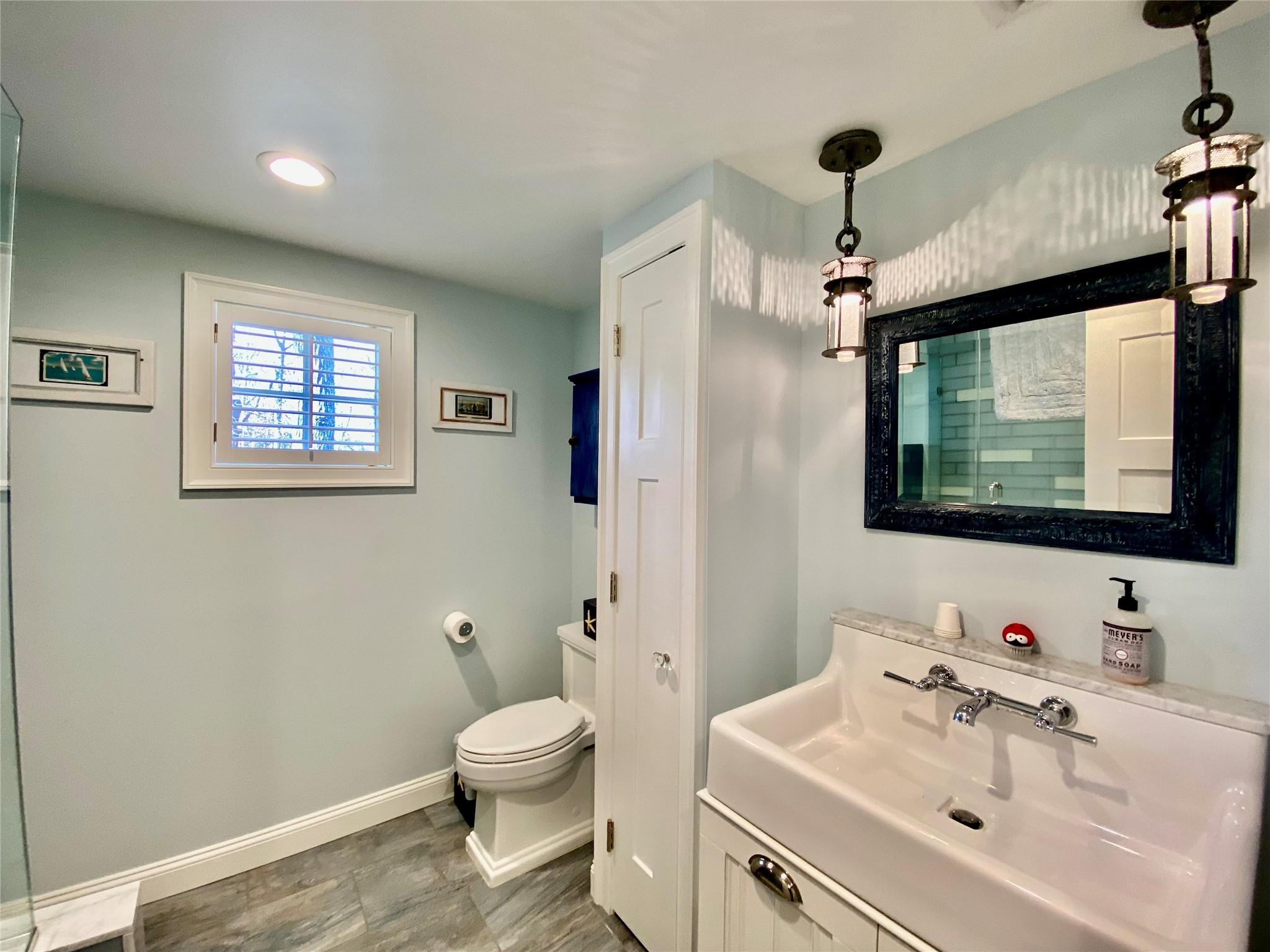 780 Minnehaha Boulevard Southold, NY 11971 - Photo 14 of 23 Bathroom featuring toilet, a shower, and vanity