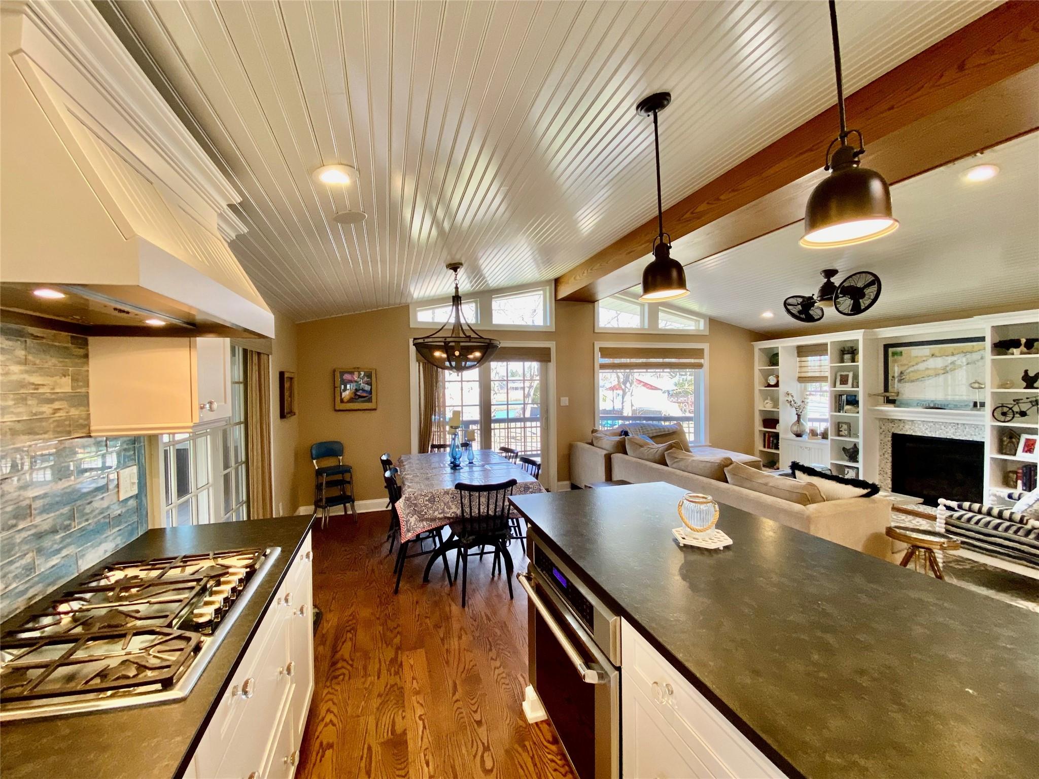 780 Minnehaha Boulevard Southold, NY 11971 - Photo 5 of 23 Kitchen with stone countertops, stainless steel gas stovetop, vaulted ceiling