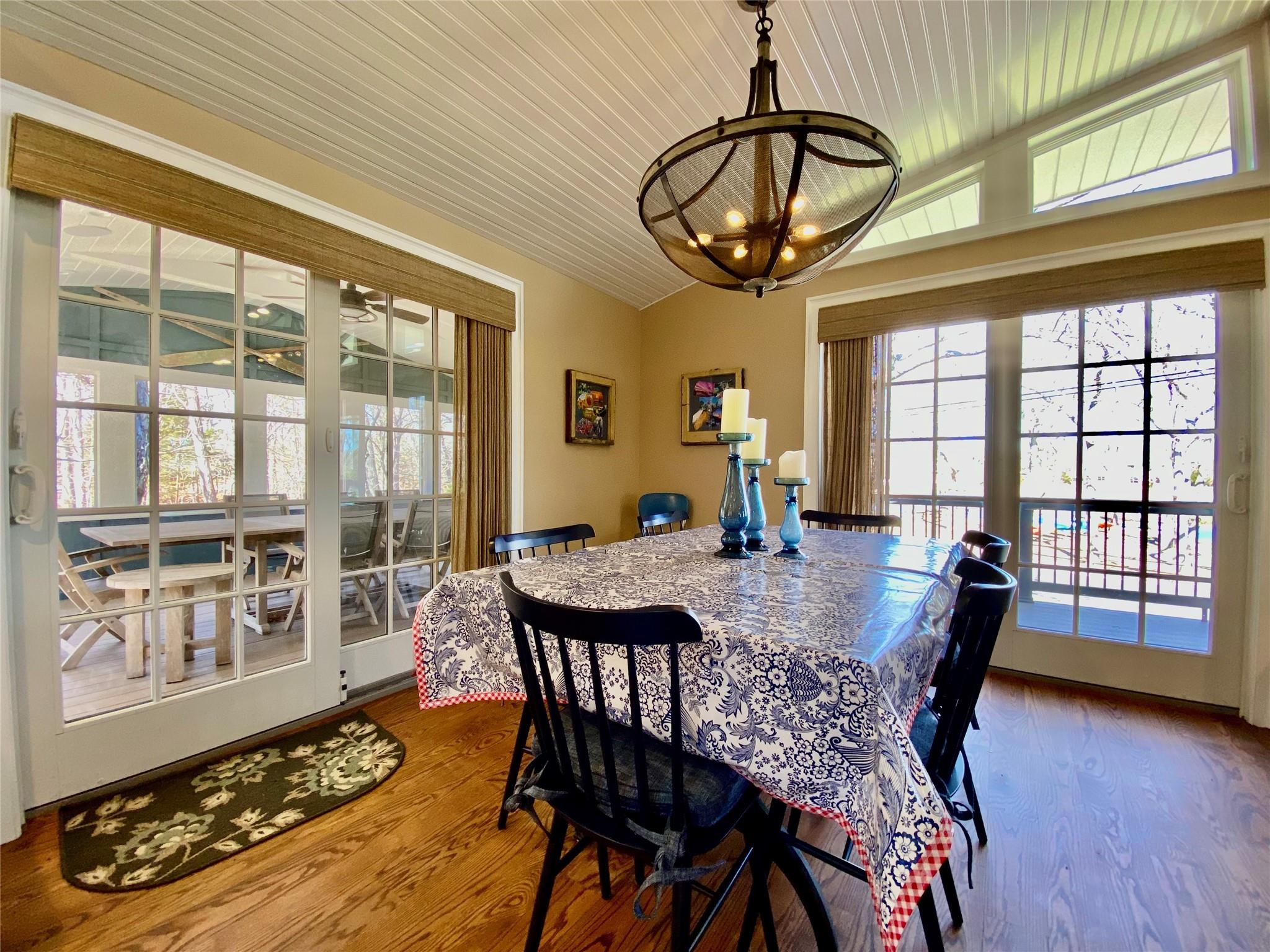 780 Minnehaha Boulevard Southold, NY 11971 - Photo 7 of 23 Dining area with vaulted ceiling, wood finished floors, wood ceiling, and an inviting chandelier