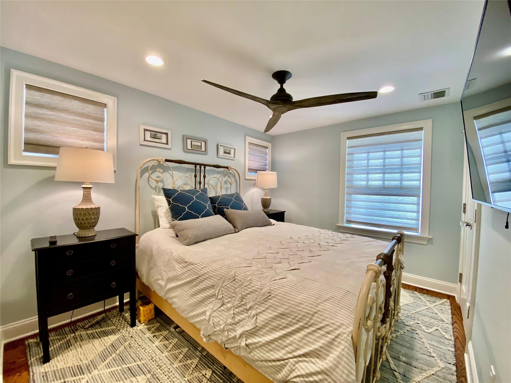 780 Minnehaha Boulevard Southold, NY 11971 - Photo 9 of 23 Bedroom featuring visible vents, baseboards, wood finished floors, recessed lighting, and a ceiling fan