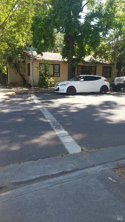 a view of street with parked cars