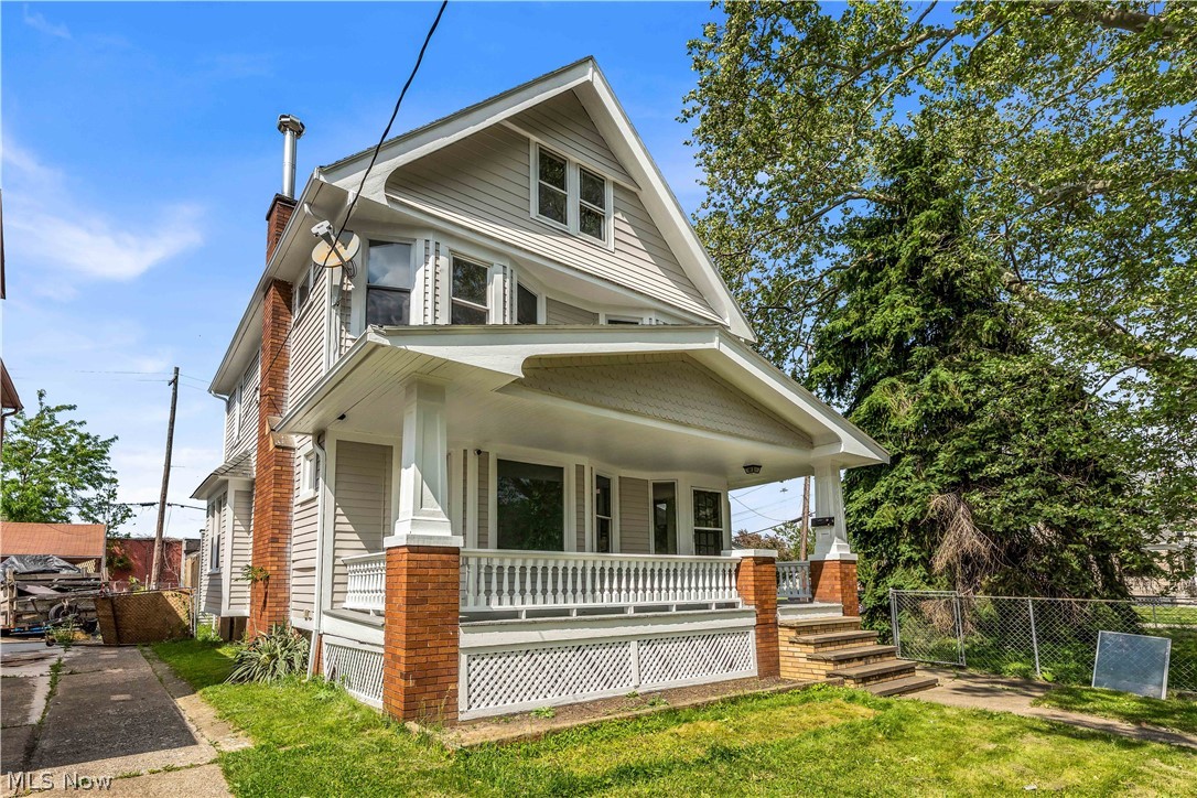 3506 Riverside Avenue Cleveland, OH 44109 - Photo 1 of 31 Two-story residence featuring light-colored siding and a covered front porch with brick base columns