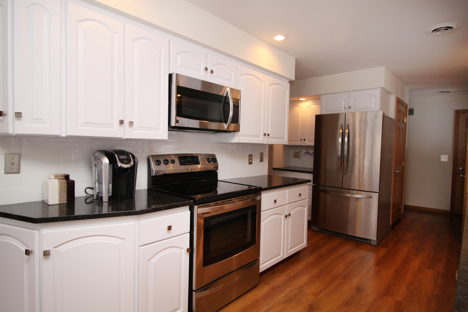 2002 Hawthorn Road Marengo, IL 60152 - Photo 7 of 27 a kitchen with stainless steel appliances a refrigerator stove and white cabinets