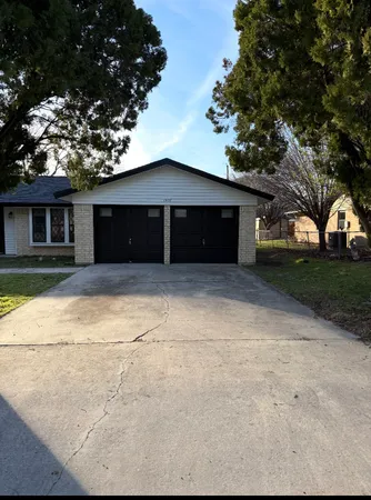 a house that has a tree in front of it