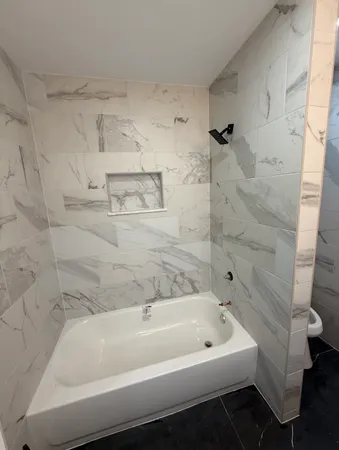 a bathroom with a toilet and a shower
