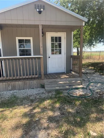 a view of backyard with deck and outdoor seating