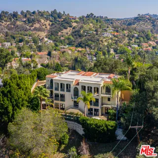 an aerial view of a house with yard swimming pool and outdoor seating