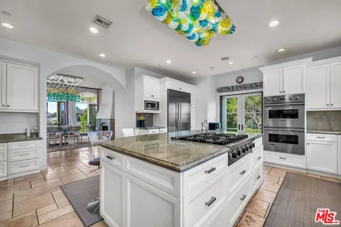 a bedroom with bed and a chandelier