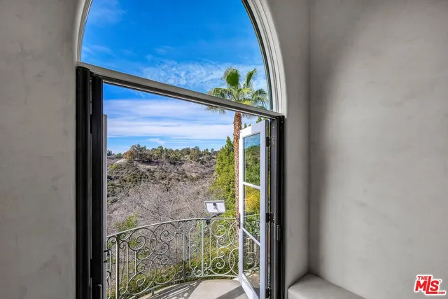 a bathroom with a sink a mirror a vanity and a shower