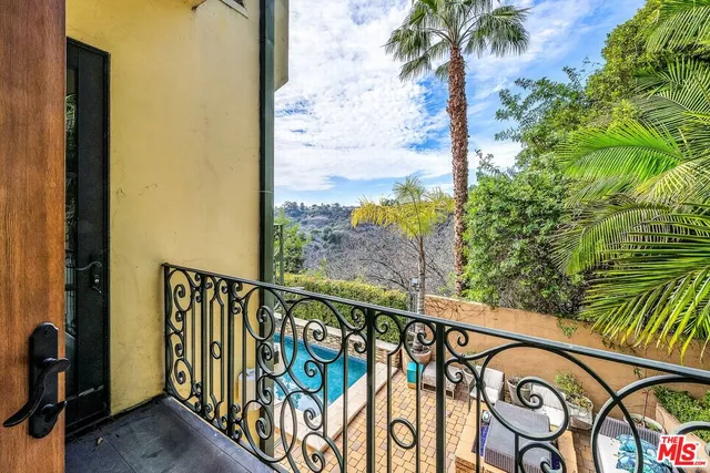 a bedroom with a large bed and a large window