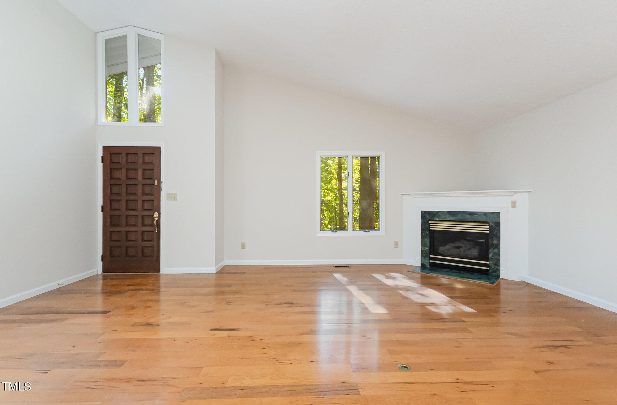 1423 Davis Road Hillsborough, NC 27278 - Photo 3 of 40 a view of an empty room with a window and fire place