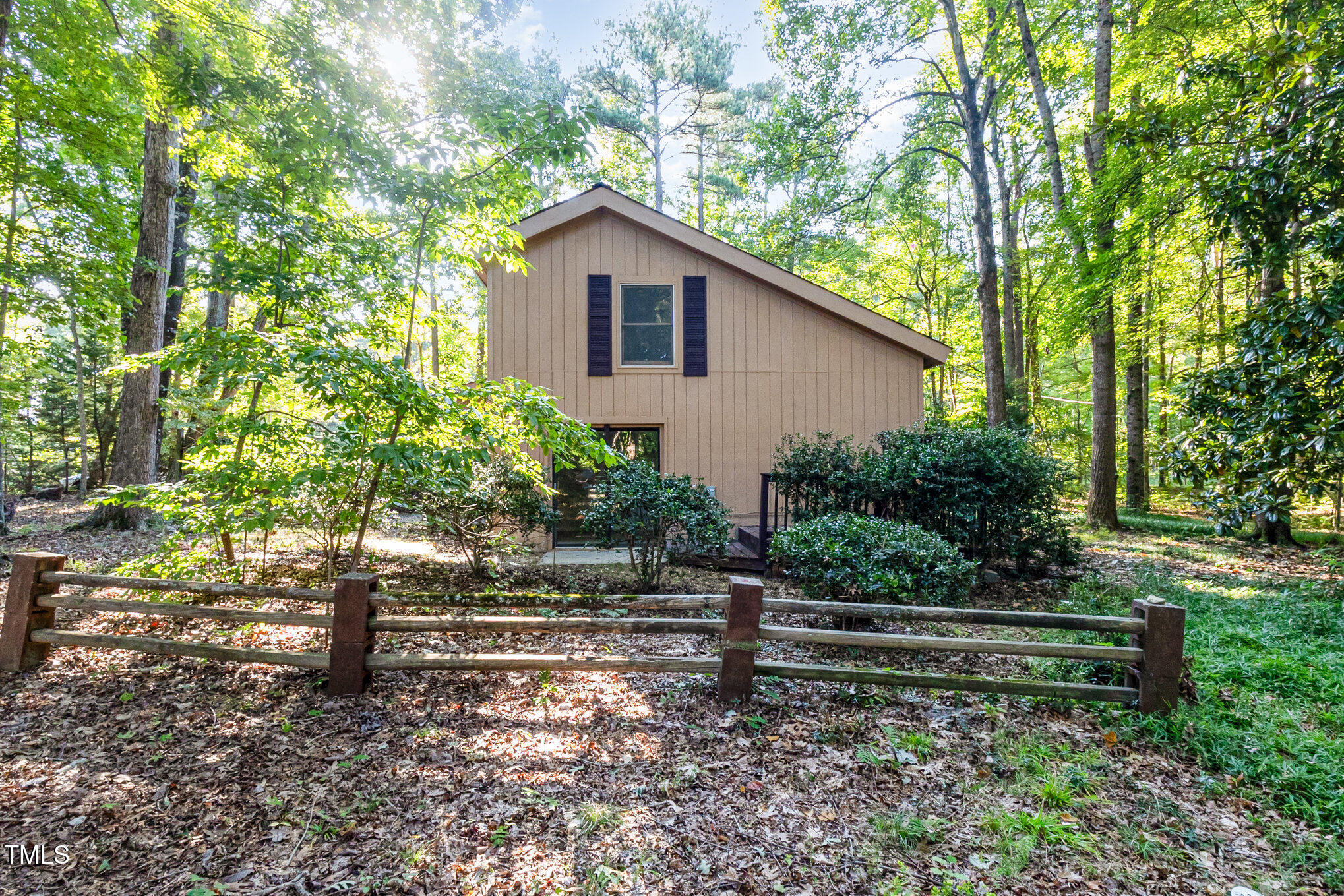 1423 Davis Road Hillsborough, NC 27278 - Photo 35 of 40 a view of a wooden house with a yard and large trees