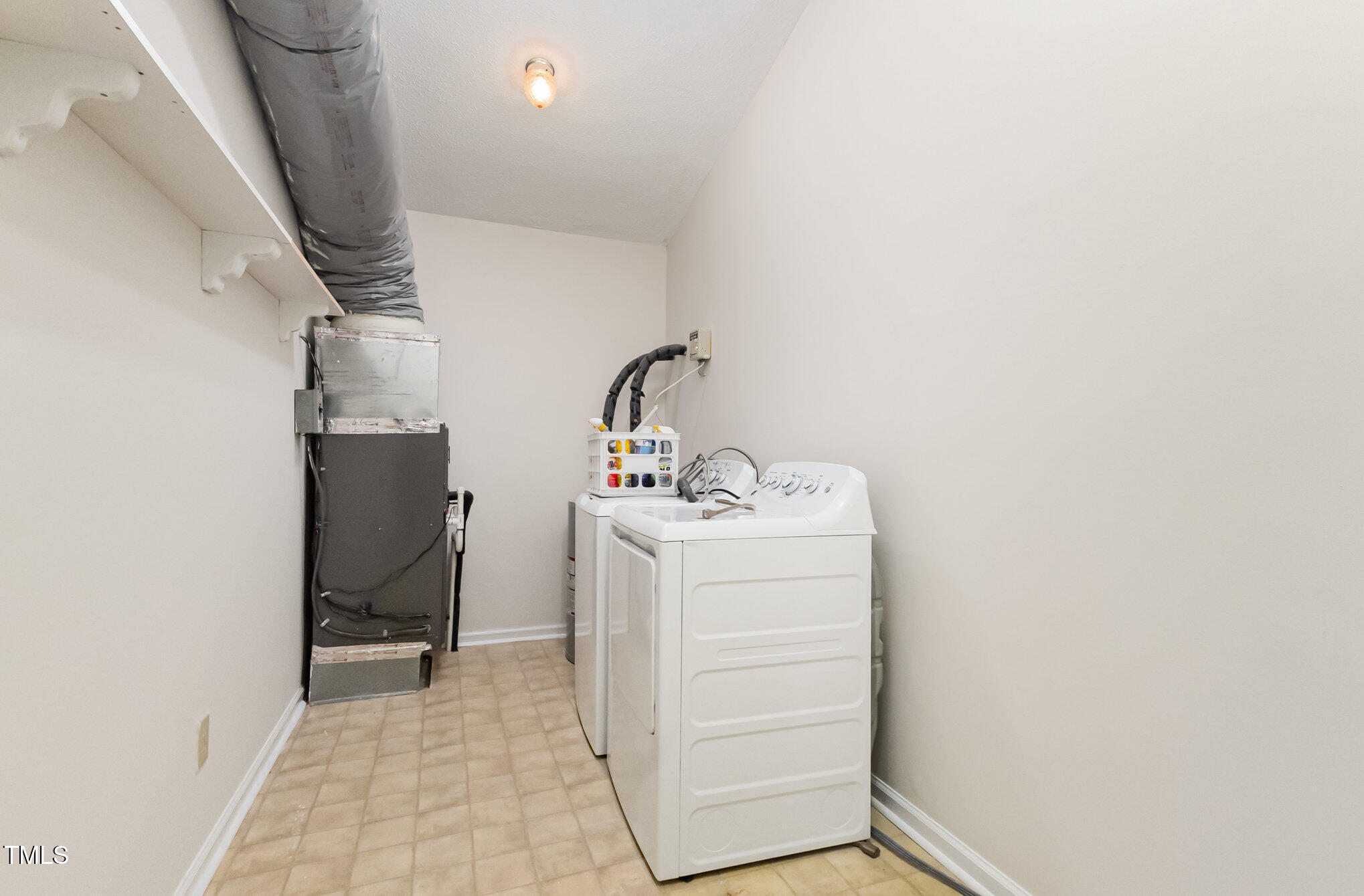 1423 Davis Road Hillsborough, NC 27278 - Photo 10 of 40 a view of storage and utility room with washer and dryer