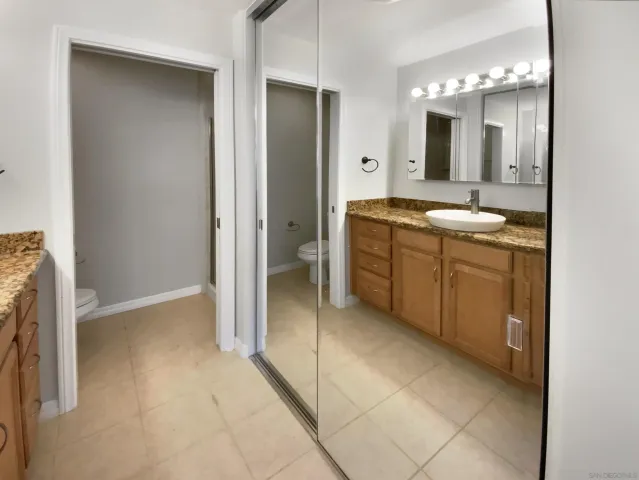 a spacious bathroom with a double vanity sink and a mirror